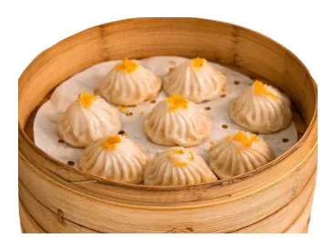 Translucent-skinned steamed xiaolongbao with juicy pork filling at BBQ House